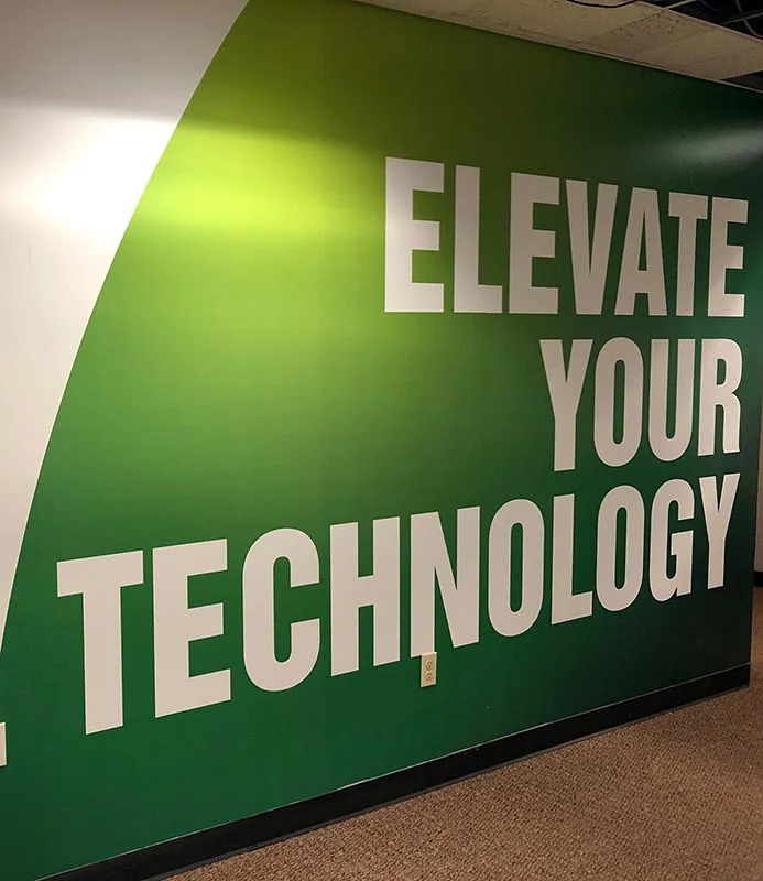 Green ProStratus office wall displaying the words Elevate Your Technology.