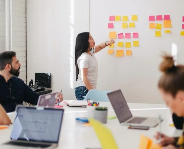 Team planning managed services with a wall of notes