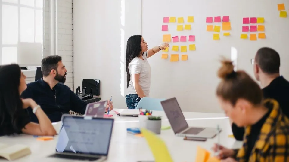 Team planning managed services with a wall of notes